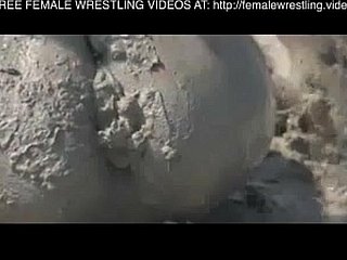 Girls wrestling roughly a catch mud